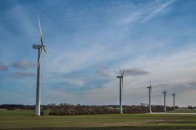 Windmills in landscape outside grenaa, denmark