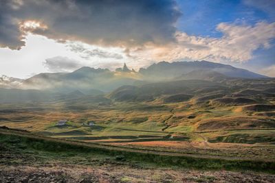 Scenic view of mountains against cloudy sky