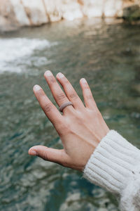 Close-up of woman hand on water