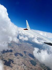 Cropped image of airplane wing against sky