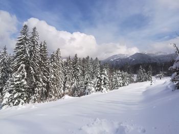 Scenic view of snow covered mountains against sky