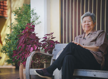 Portrait of young woman sitting on chair
