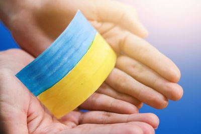 Cropped hand of woman holding container