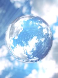 Low angle view of bubbles against blue sky