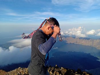 Side view of senior woman against mountains