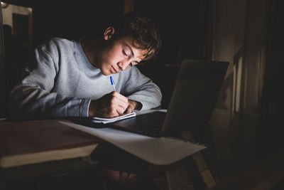 Teenage boy studying at home