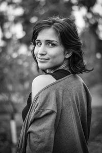 Portrait of smiling woman standing outdoors