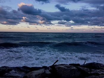 Scenic view of sea against cloudy sky