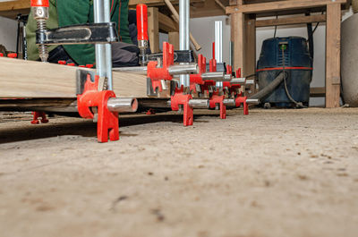 Wooden board in carpentry workshop. joiner's clamp. wood shavings, sawdust