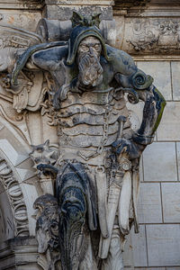 Low angle view of buddha statue against wall