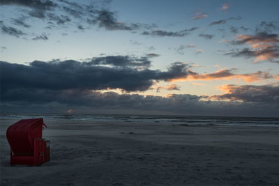 Scenic view of beach against sky during sunset