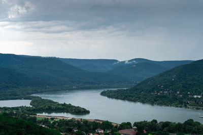 Scenic view of river and mountains against sky