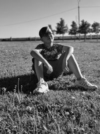 Young woman sitting on field