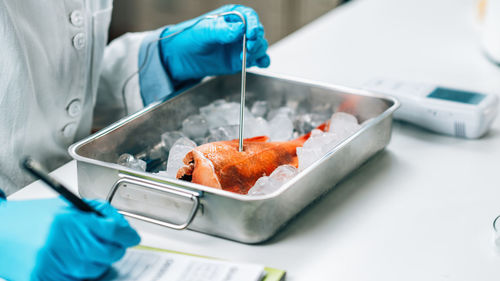 Fish quality control - food safety inspector searching for the presence heavy metals 