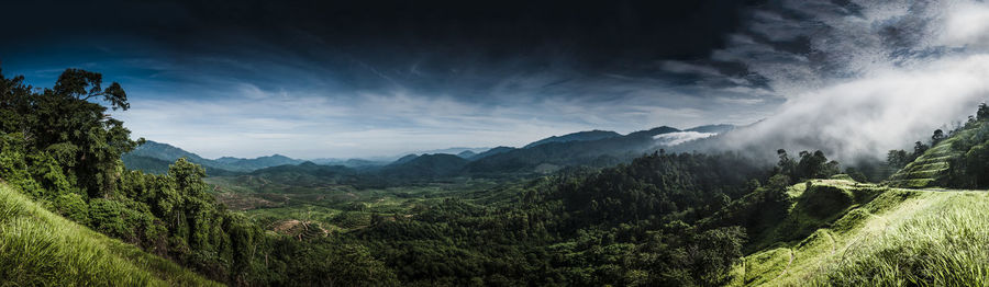 Scenic view of mountains against cloudy sky