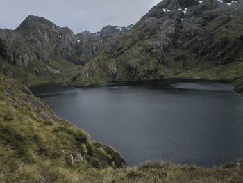 Scenic view of river amidst mountains against sky