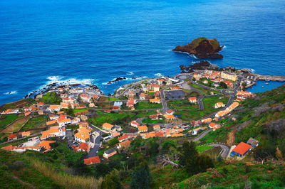 High angle view of townscape by sea