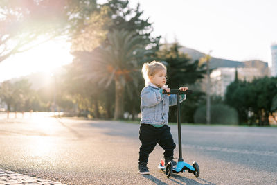 Full length of boy standing on road