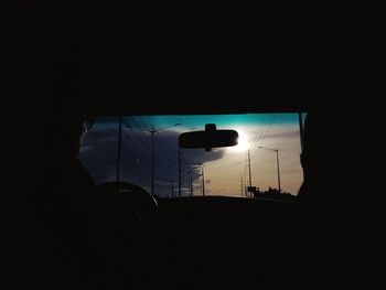 Silhouette people in car against sky during sunset