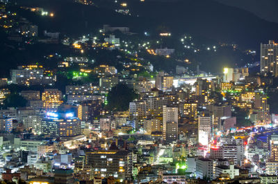 High angle view of illuminated city buildings at night