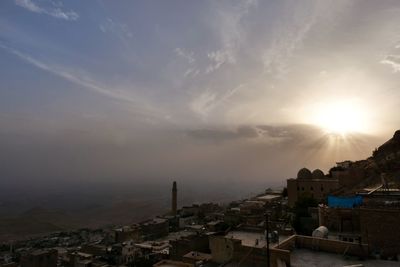 High angle view of buildings against sky at sunset