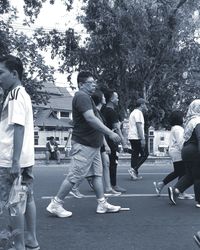 People on street amidst trees