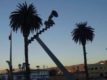 Silhouette palm tree against blue sky