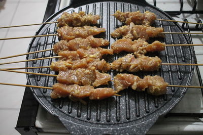 High angle view of satay on barbecue grill