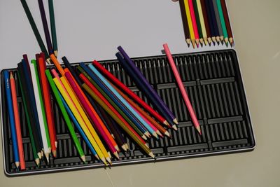 Close-up of multi colored pencils in row