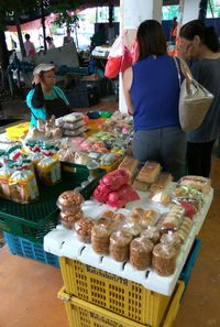 People and vegetables for sale in market