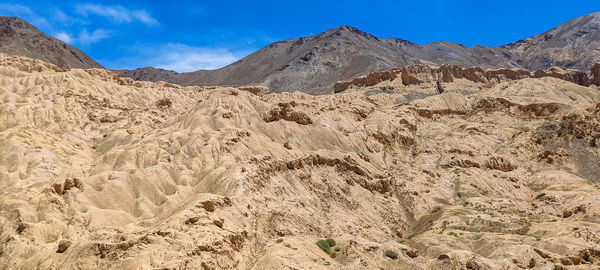 Scenic view of arid landscape against sky