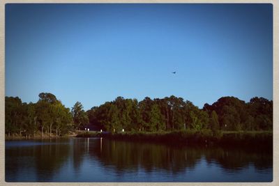 Scenic view of calm lake against clear sky