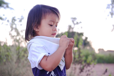 Girl standing on land against clear sky