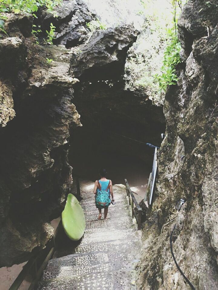 lifestyles, full length, rear view, leisure activity, men, rock - object, the way forward, walking, nature, rock formation, water, tree, person, beauty in nature, tranquility, day, transportation, casual clothing