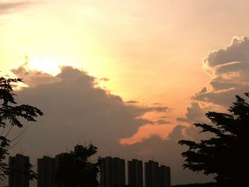 Low angle view of silhouette buildings against sky during sunset