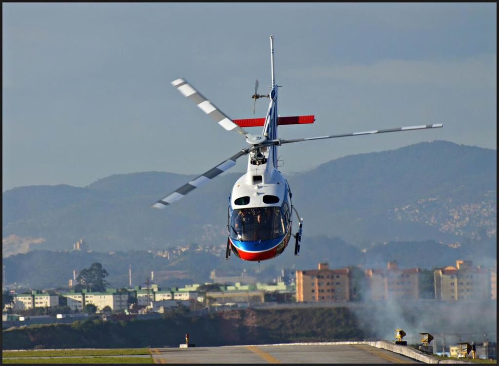 flying, mid-air, air vehicle, transportation, sky, mode of transportation, nature, motion, helicopter, airplane, mountain, day, architecture, building exterior, outdoors, on the move, travel, built structure, propeller, city, aerospace industry