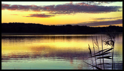 Scenic view of lake at sunset