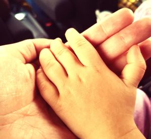 Close-up of couple holding hands