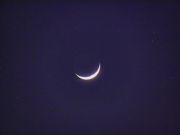 Low angle view of moon against sky at night
