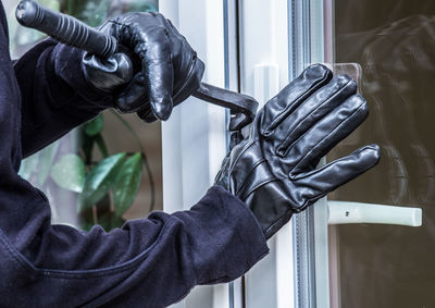 Close-up of man working on window