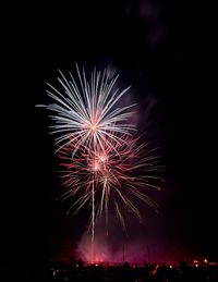 Low angle view of firework display at night
