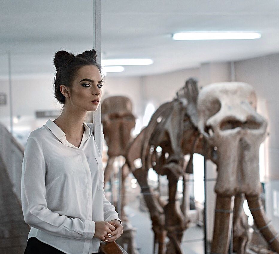 WOMAN STANDING IN MUSEUM