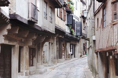 Narrow street amidst old buildings in town