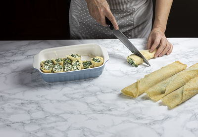 Cropped hand of person preparing food