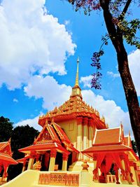 Low angle view of temple against cloudy sky