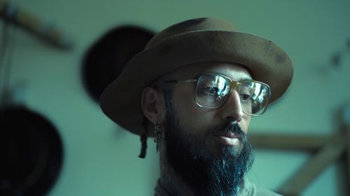 Close-up of thoughtful man wearing hat