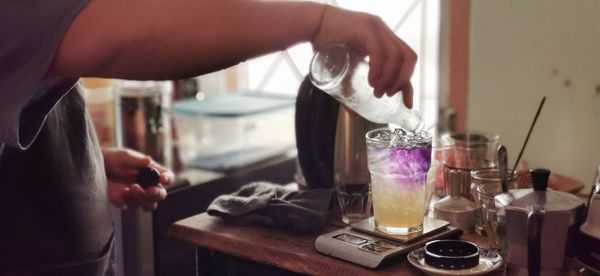 Midsection of man preparing food in kitchen