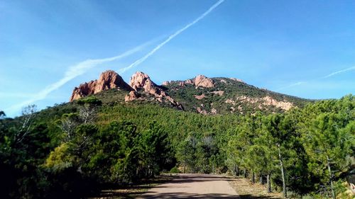 Scenic view of mountains against blue sky