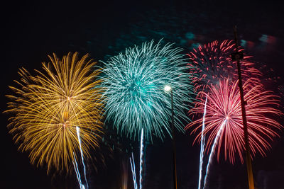 Low angle view of firework display at night