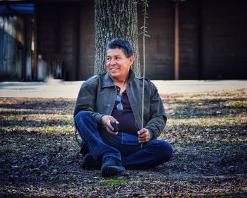 Portrait of young man sitting outdoors